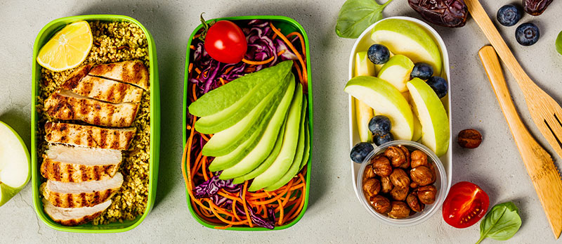 Containers full of healthy food as part of a meal prep plan.