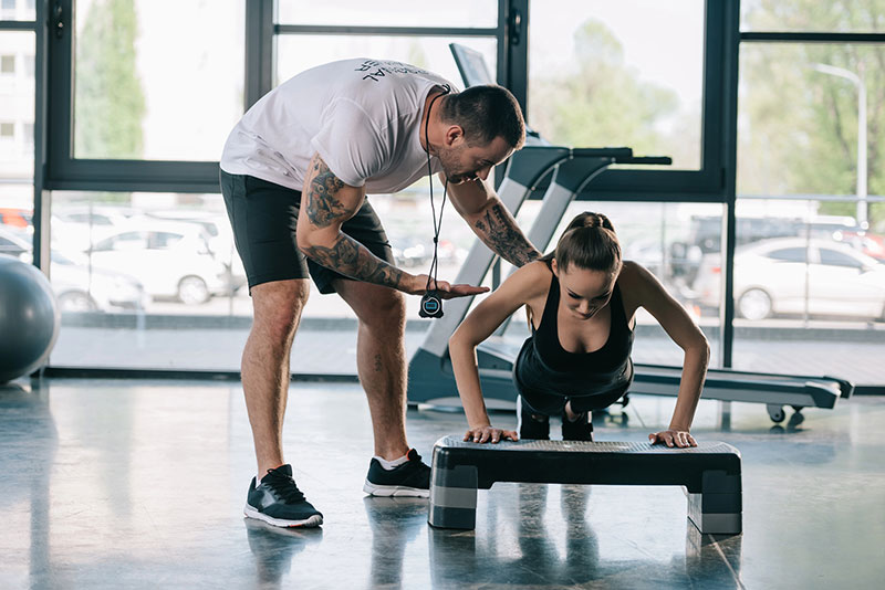 Personal trainer training a client.